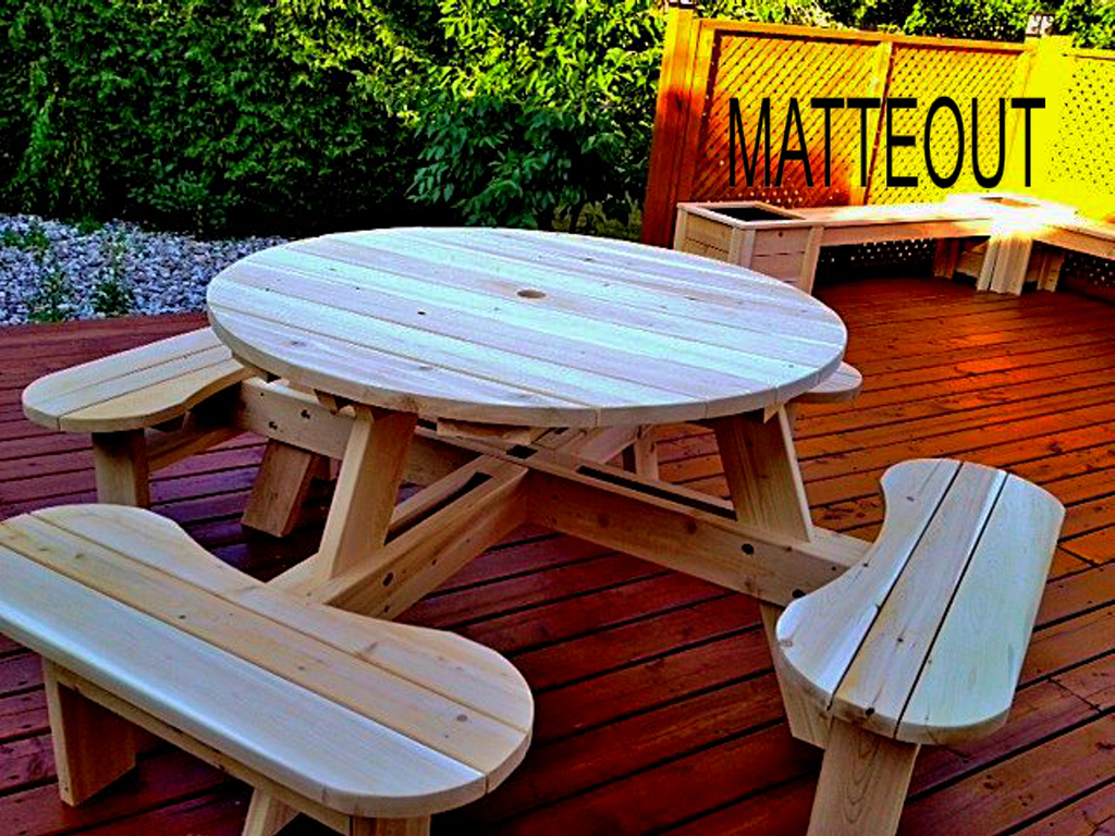 Handcrafted round white cedar picnic table with built-in curved bench seating on an outdoor wooden deck by Matteout Woodworking.